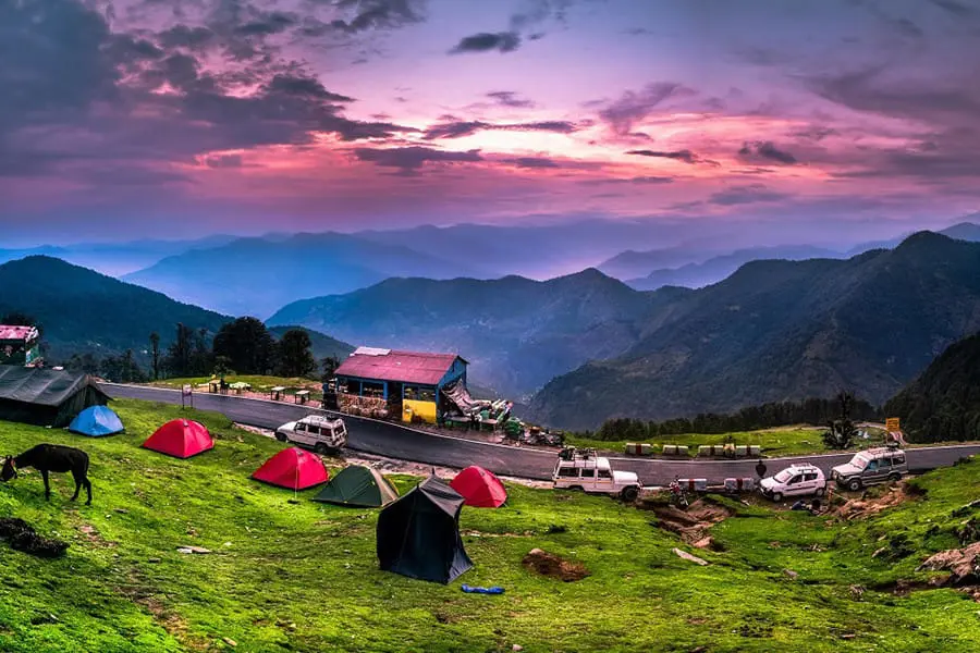 Kanatal hillside with scattered houses and distant snowy peaks