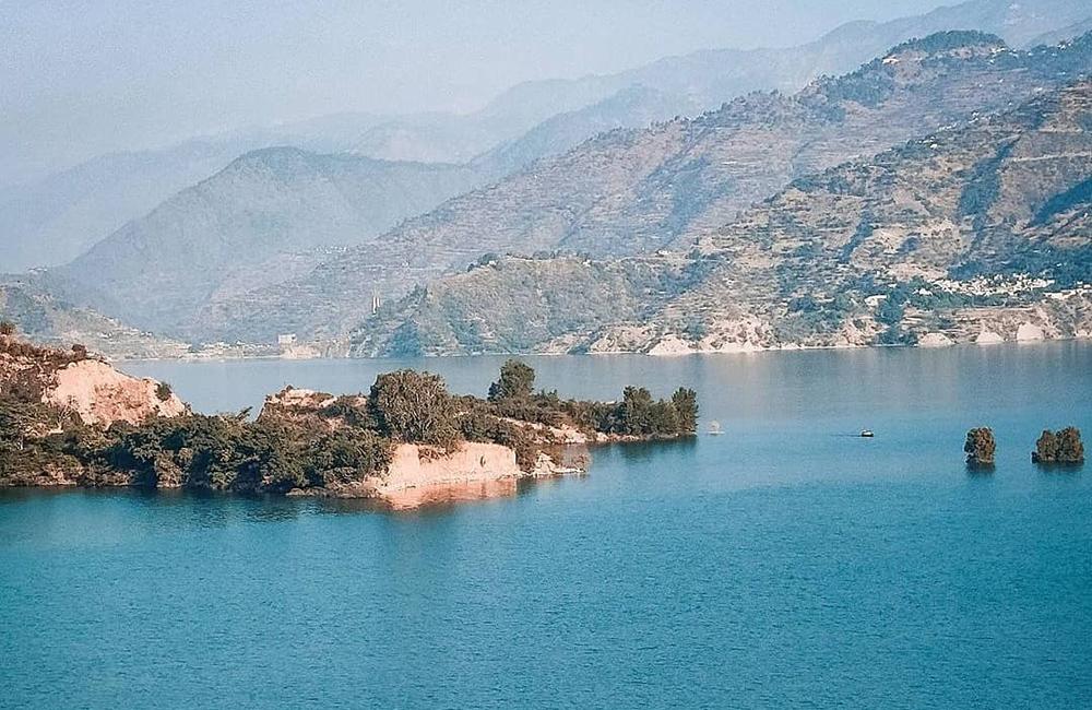 Close-up of Tehri Dam with surrounding green hills in New Tehri